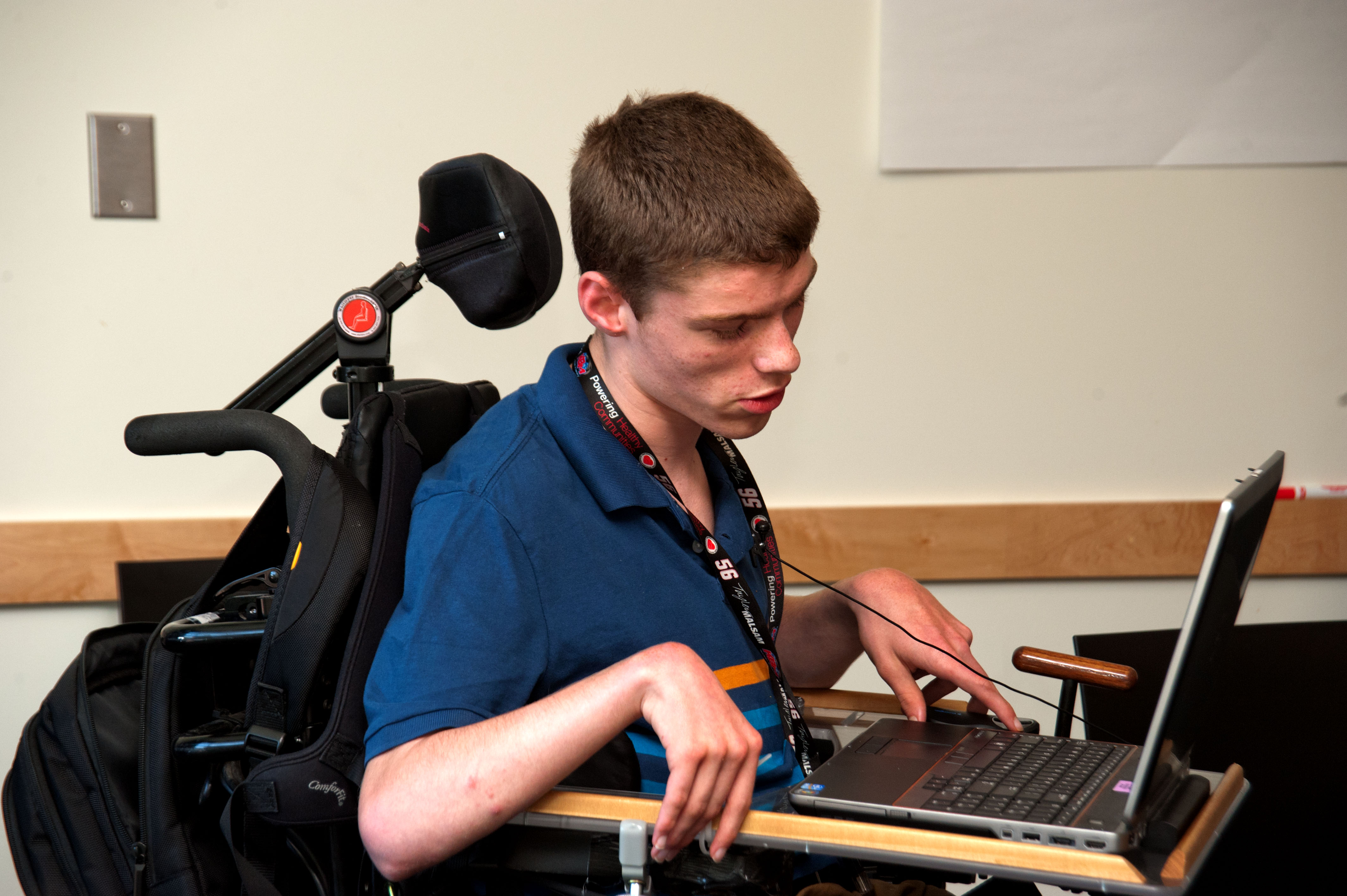Accessible computing for students with disabilities Image of student who uses a wheelchair, using a laptop.