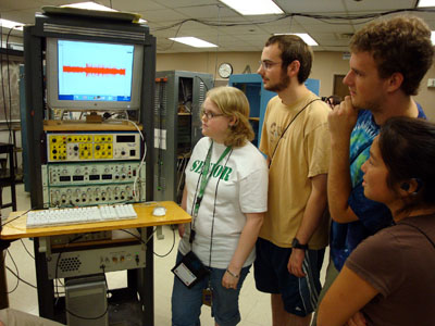 A group of students looks at a computer screen