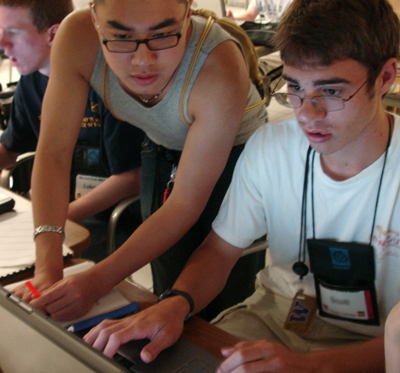 A student helps a peer use a computer